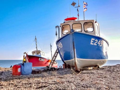two boats sitting on the shore of a beach at Haslemere - Beer Devon in Beer