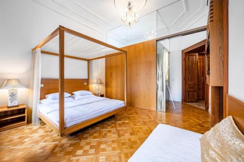 a bedroom with a canopy bed and a mirror at Malostranská Residence in Prague