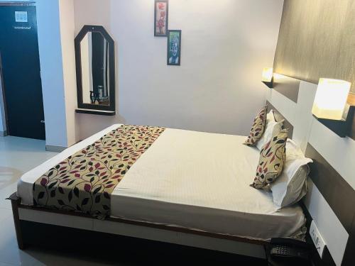 a bedroom with a bed in a room at Hotel Mani International in Patna