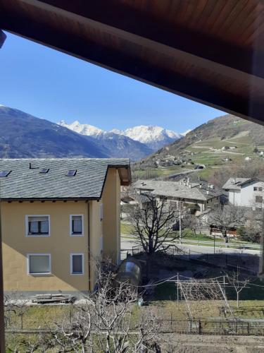 a view from a house with mountains in the background at Graziosa mansarda rustica - CIR VDA 0038 in Aosta