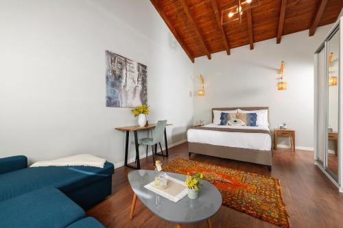 a living room with a bed and a blue couch at Blerina Farm House in Laknas