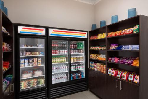 a grocery store with two refrigerators and lots of food at Country Inn & Suites by Radisson, Katy Houston West , TX in Katy