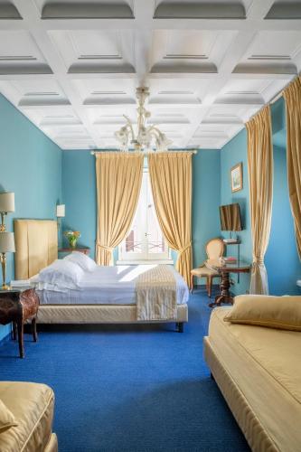 a blue bedroom with a bed and a window at Hotel Scalinata Di Spagna in Rome