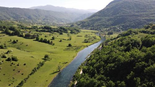 an aerial view of a river in a valley at Nomad Glamping in Šipovo