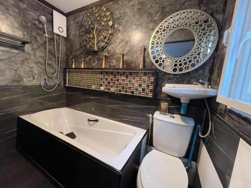 uma casa de banho com uma banheira, um lavatório e um WC. em Do Dee Cafe Bangkok Hostel em Bangkok