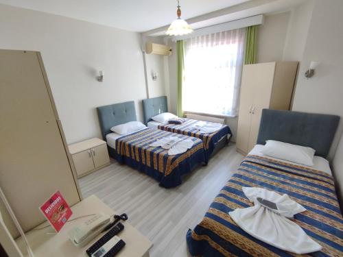 Postel nebo postele na pokoji v ubytování Anadolu Hotel