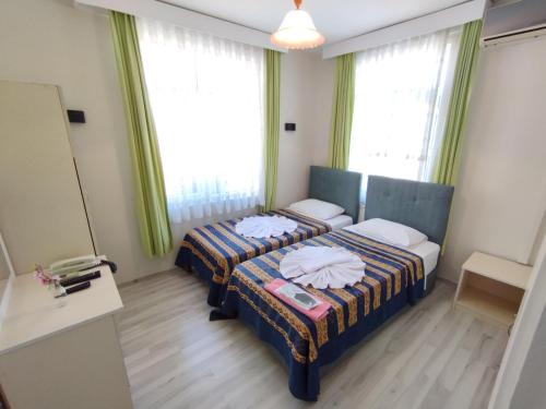 Postel nebo postele na pokoji v ubytování Anadolu Hotel