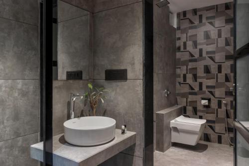 a bathroom with a sink and a toilet at Hotel Padmawati Grand in Nānded