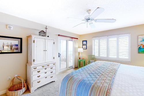 a bedroom with a bed and a ceiling fan at Sandy Key 3-532 in Perdido Key