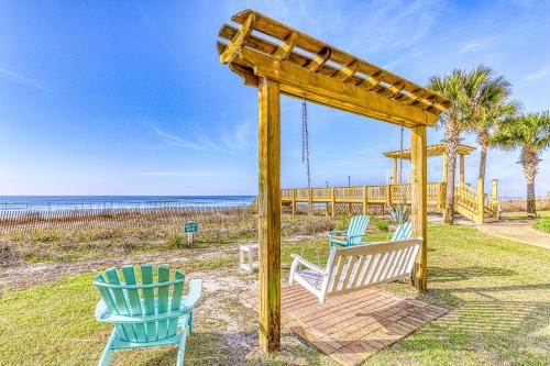 two chairs and a wooden gazebo on the beach at Sandy Key 3-532 in Perdido Key