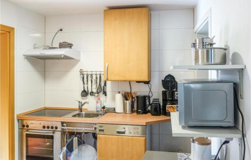 a small kitchen with a sink and a microwave at 2 Bedroom Amazing Apartment In Loxstedt in Loxstedt