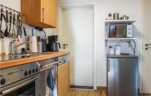 a kitchen with a stove and a microwave at 2 Bedroom Amazing Apartment In Loxstedt in Loxstedt