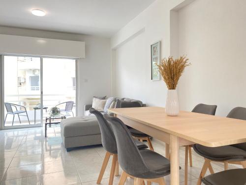 a dining room with a table and chairs at Phaedrus Living Down Town Flat Nestoras 301 in Limassol