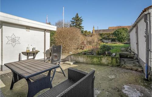 a patio with a table and chairs in a yard at Beautiful Home In Assens With Wifi in Assens