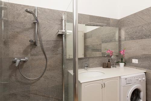 a bathroom with a shower and a sink and a shower at Bellavista Apartments - By Impero House in Levo