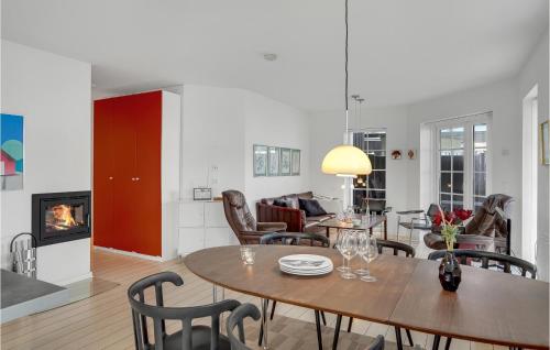 a living room with a table and chairs and a fireplace at Lovely Home In Bogense With Kitchen in Bogense