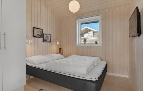a bed in a room with a window at 3 Bedroom Nice Home In Haarby in Hårby