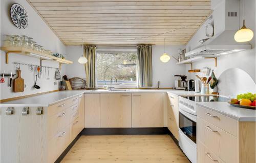 a kitchen with white cabinets and a sink at Amazing Home In Nykøbing Sj With Wifi in Bøsserup