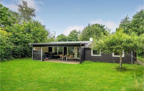 a small black house with a yard at Amazing Home In Nykøbing Sj With Wifi in Bøsserup