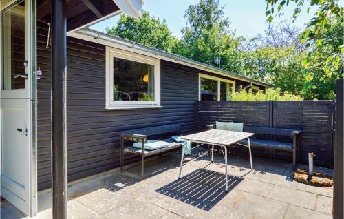a patio with a table and chairs and a fence at Amazing Home In Nykøbing Sj With Wifi in Bøsserup