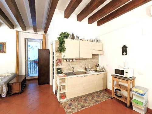 a kitchen with white cabinets and a sink in a room at La Casa Delle Fate in Siracusa