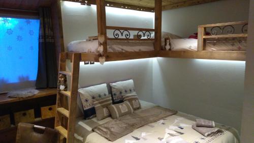 a room with two bunk beds in a room at LE BAROQUE in Aime-La Plagne