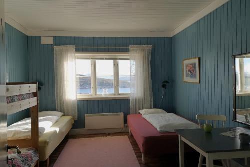 a bedroom with a bed and a window at Tranøy Fyr in Tranøy