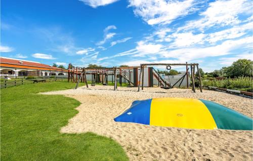 a playground with a slide and a swing set at Lovely Home In Tranekær in Tranekær