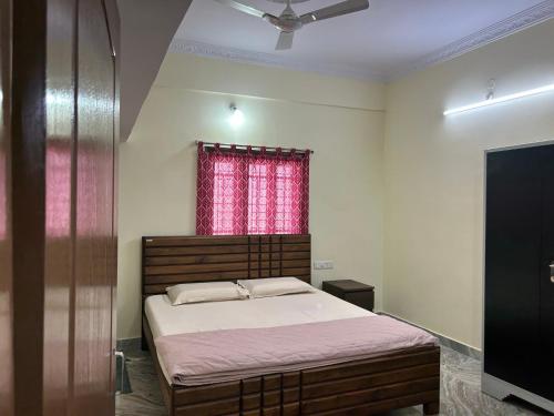 a bedroom with a bed and a red window at Home to explore Food, History & Shopping in Hyderabad