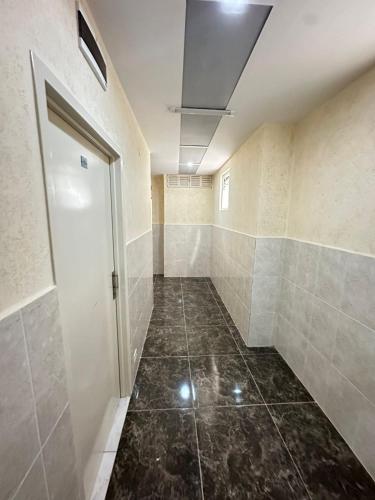 a bathroom with a hallway with a door and a tile floor at Centro1555 in Buenos Aires