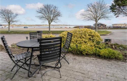 a table with two chairs and a table with fruit on it at 3 Bedroom Gorgeous Home In Broager in Broager