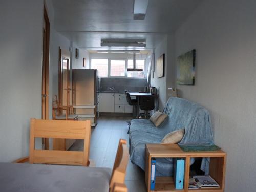 a living room with a couch and a table at Ferienwohnung Ernatsreute in Überlingen