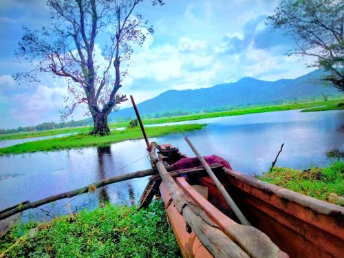 a boat sitting on the side of a river at Lake Front Yala Safari in Kataragama