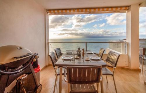 a dining room with a table and a view of the ocean at 3 Bedroom Cozy Apartment In Santa Pola in Santa Pola