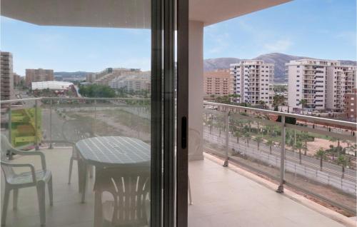 a balcony with a table and a view of a city at Cozy Apartment In Oropesa Del Mar in Oropesa del Mar