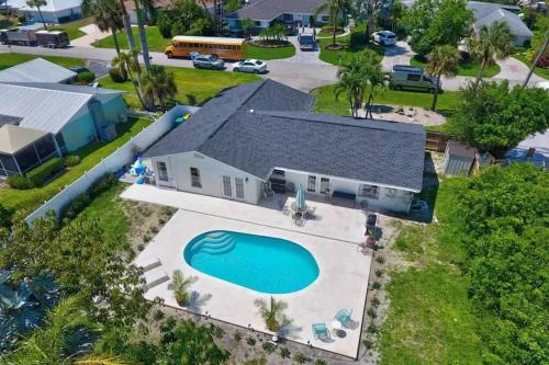 an aerial view of a house with a swimming pool at HIDDEN GEM - Family Friendly Pool Home -Welcome in Naples