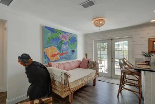 a woman standing in a living room with a couch at Turtle Island - Family Friendly Pool Home -Welcome in Naples