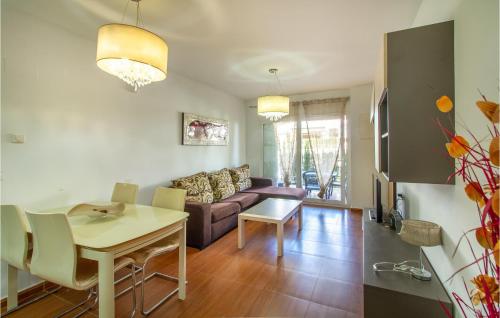 a living room with a couch and a table at Cozy Apartment In Torrevieja With Wifi in Torrevieja
