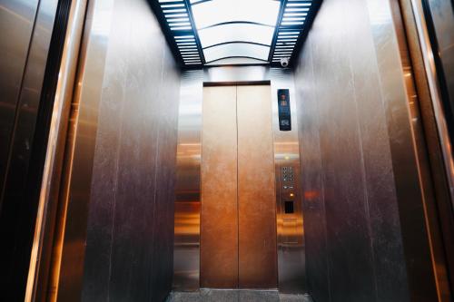 an elevator corridor in a building with wooden doors at 龍江大飯店 in Shuili