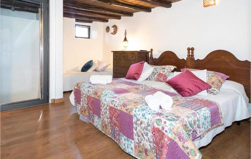 1 dormitorio con 1 cama grande con almohadas rosas en 3 Bedroom Nice Home In Castao Del Robledo, en Castaño de Robledo
