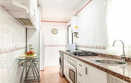 a white kitchen with a sink and a counter at 3 Bedroom Cozy Apartment In Huelva in Huelva
