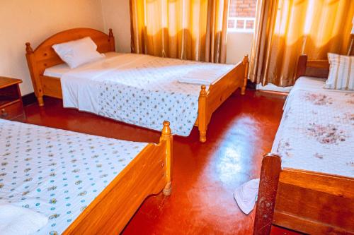 a room with two beds and twoperate at MOUCECORE in Kigali
