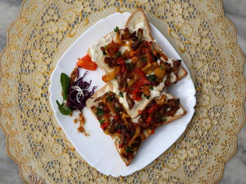 a plate with two slices of pizza on a table at Hotel Pleasure Home in Kathmandu
