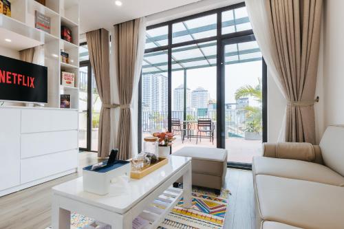 a living room with a table and a couch at LUCK APART 9 - Hanoi WestLake Balcony Apartment in Hanoi