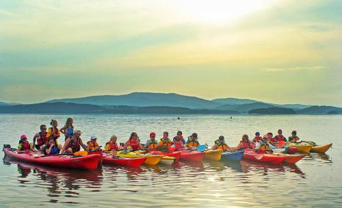 a group of people in kayaks on the water at Apartmány Pinie Lipno in Lipno nad Vltavou
