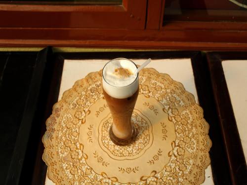 a glass of beer on a plate on a table at Hotel Pleasure Home in Kathmandu
