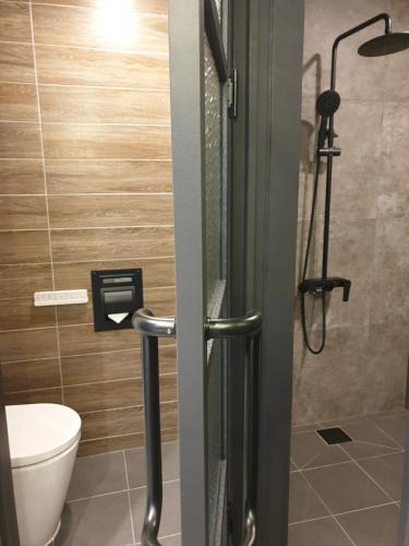 a bathroom with a shower with a toilet and a shower at Sokcho Business Hotel CAMEL in Sokcho