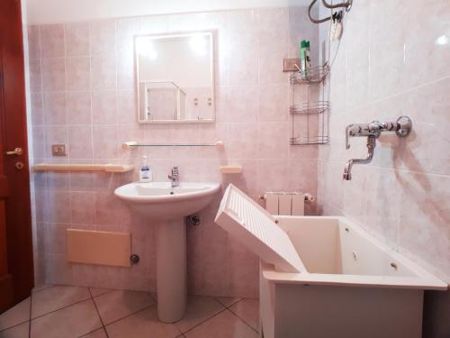 a bathroom with a sink and a bath tub at Palau Sea View apartment in Palau