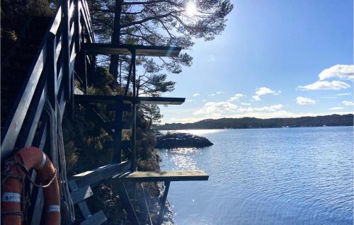 a view of a body of water next to a fence at Amazing Home In Mosterhamn in Mosterhamn