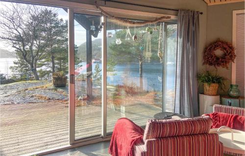 a living room with a large sliding glass door at Amazing Home In Mosterhamn in Mosterhamn
